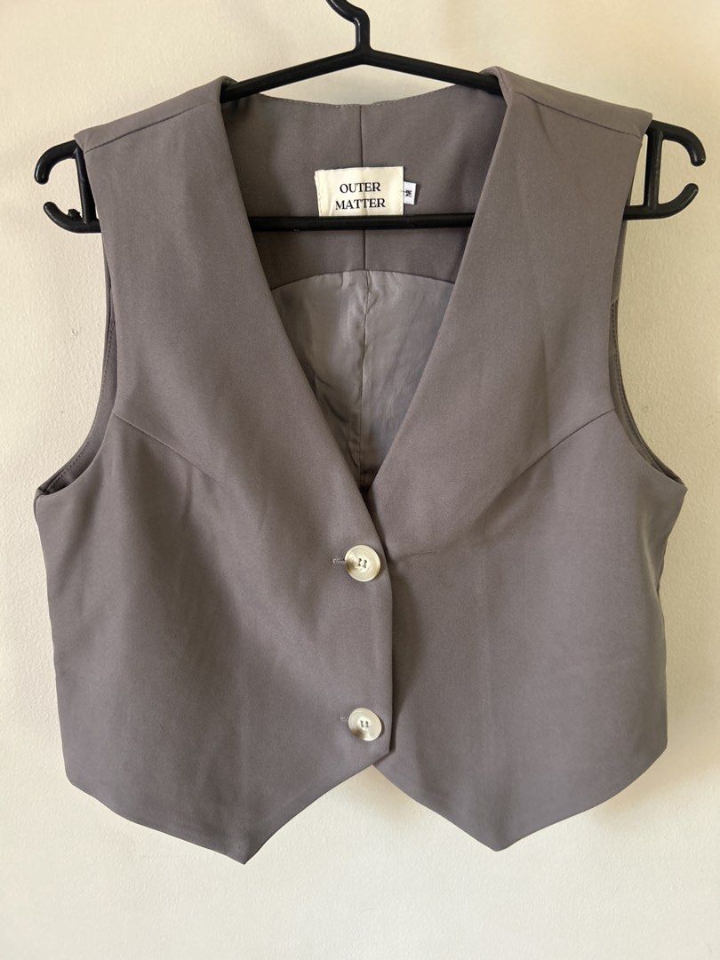 Grey Button-Up Cropped Vest from Bangkok (Category: Sleeveless) located in Pasig City. Submitted by frooozenbrazo (Listing ID 1462707763, Image 1). Description: - Grey vest from Bangkok - Classic cut with two-button front closure - Lined interior - Ideal for layering over shirts or dresses - Versatile addition to any wardrobe - Super good quality and thick material.
