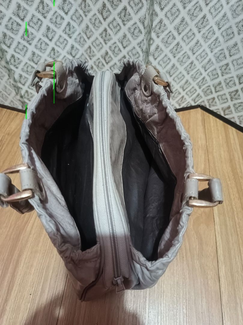 Grey Handbag with Braided Detail (Category: Shoulder Bags) located in Makati City. Submitted by nyxhemera26 (Listing ID 1462827401, Image 3). Description: Grey Handbag with Braided Detail 🚫 WITH MINIMAL RUBBINGS, SEE PHOTOS 🚫 NEEDS CLEANING - Unique braided detail on the front - Secure drawstring closure at the top - Convenient interior zippered pocket - Comfortable leather handles - Ideal for everyday use .