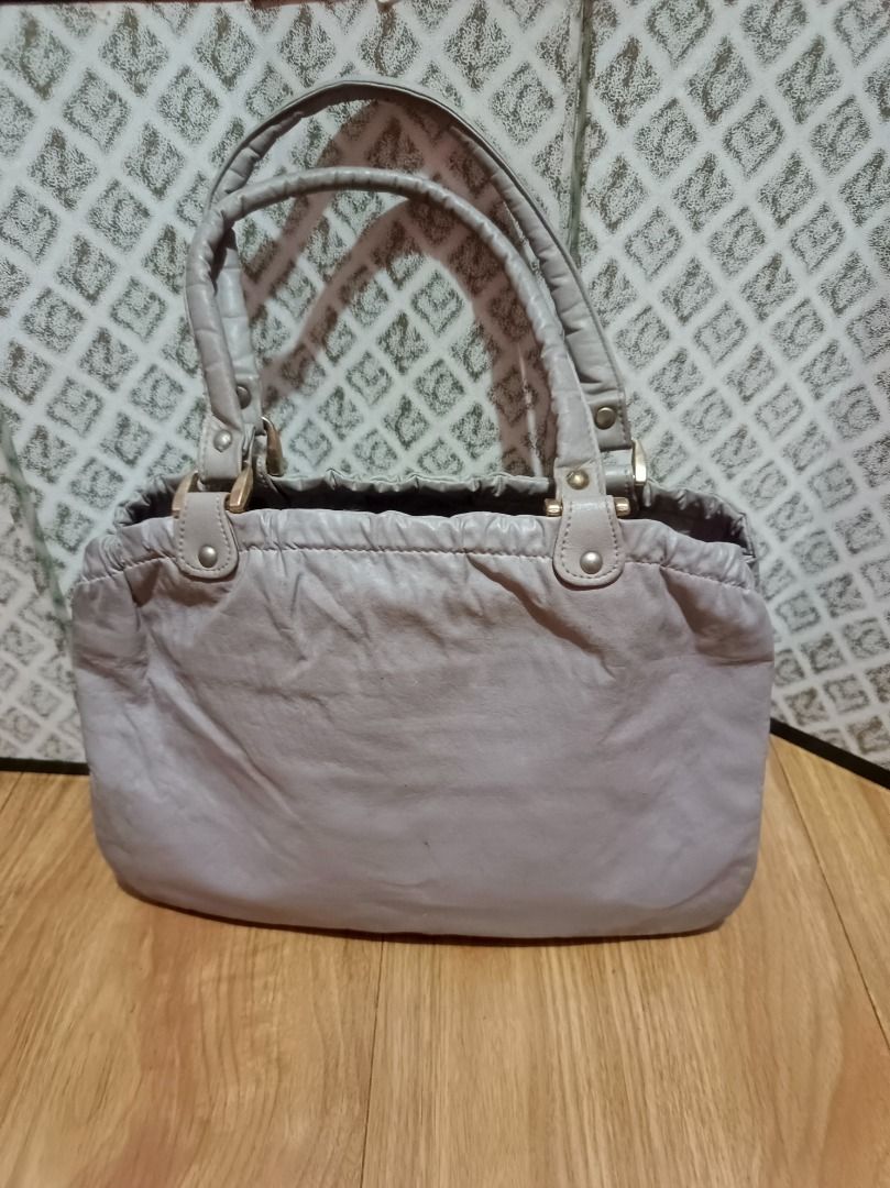 Grey Handbag with Braided Detail (Category: Shoulder Bags) located in Makati City. Submitted by nyxhemera26 (Listing ID 1462827401, Image 2). Description: Grey Handbag with Braided Detail 🚫 WITH MINIMAL RUBBINGS, SEE PHOTOS 🚫 NEEDS CLEANING - Unique braided detail on the front - Secure drawstring closure at the top - Convenient interior zippered pocket - Comfortable leather handles - Ideal for everyday use .