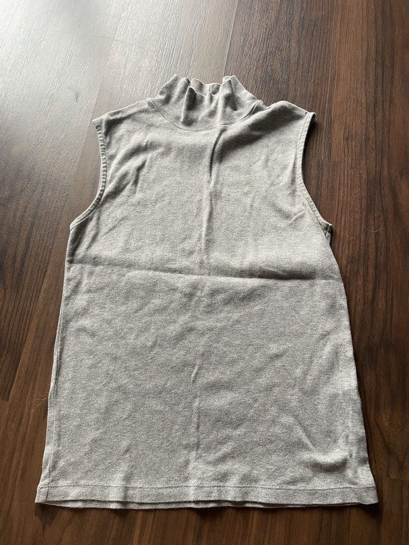 Grey Sleeveless turtle Neck Top (Category: Sleeveless) located in Quezon City. Submitted by andreaaa_______ (Listing ID 1462757792, Image 1). Description: - Grey sleeveless top - Ribbed texture - Mock neck with button closure at collar measurements in photo no brand second hand manage expectations small stretch - Tagged size L.