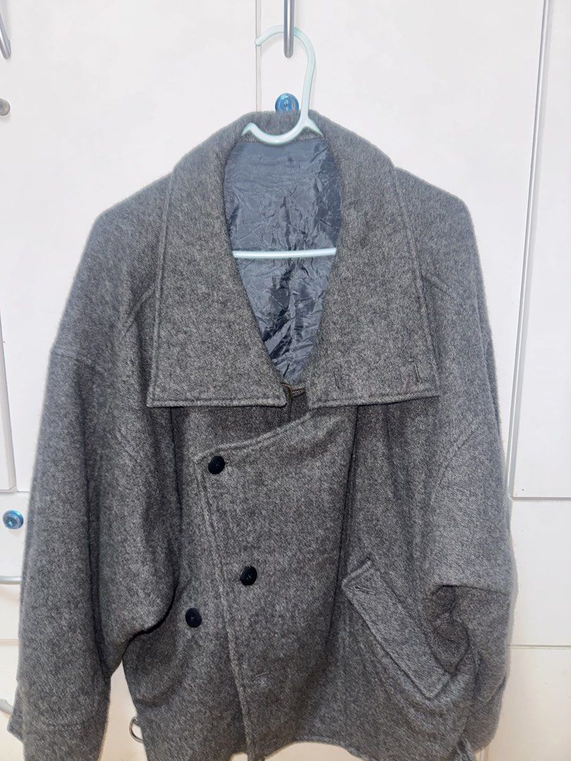 Grey Wool Double Breasted Coat (Category: Coats, Jackets and Outerwear) located in Manila. Submitted by quintessesommerset (Listing ID 1462874041, Image 2). Description: - Cool grey coat, likely a wool blend. 23x27 - Stylish double-breasted design with black buttons. - Unique collar can be worn up or down. - Features two convenient front pockets. - Ideal for keeping warm in cooler weather..