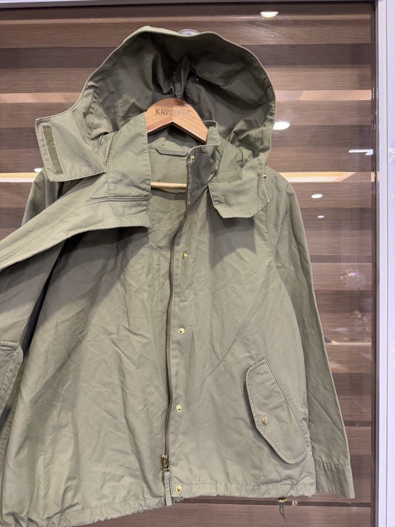 GU mountain parka (Category: Coats, Jackets and Outerwear) located in Manila. Submitted by kristinata44809 (Listing ID 1462881399, Image 3). Description: - Lightweight green jacket from GU - Features a hood - Drawstring waist for adjustable fit - Two front pockets with button closure - Button and zip front closure - Ideal for layering and casual outfits.