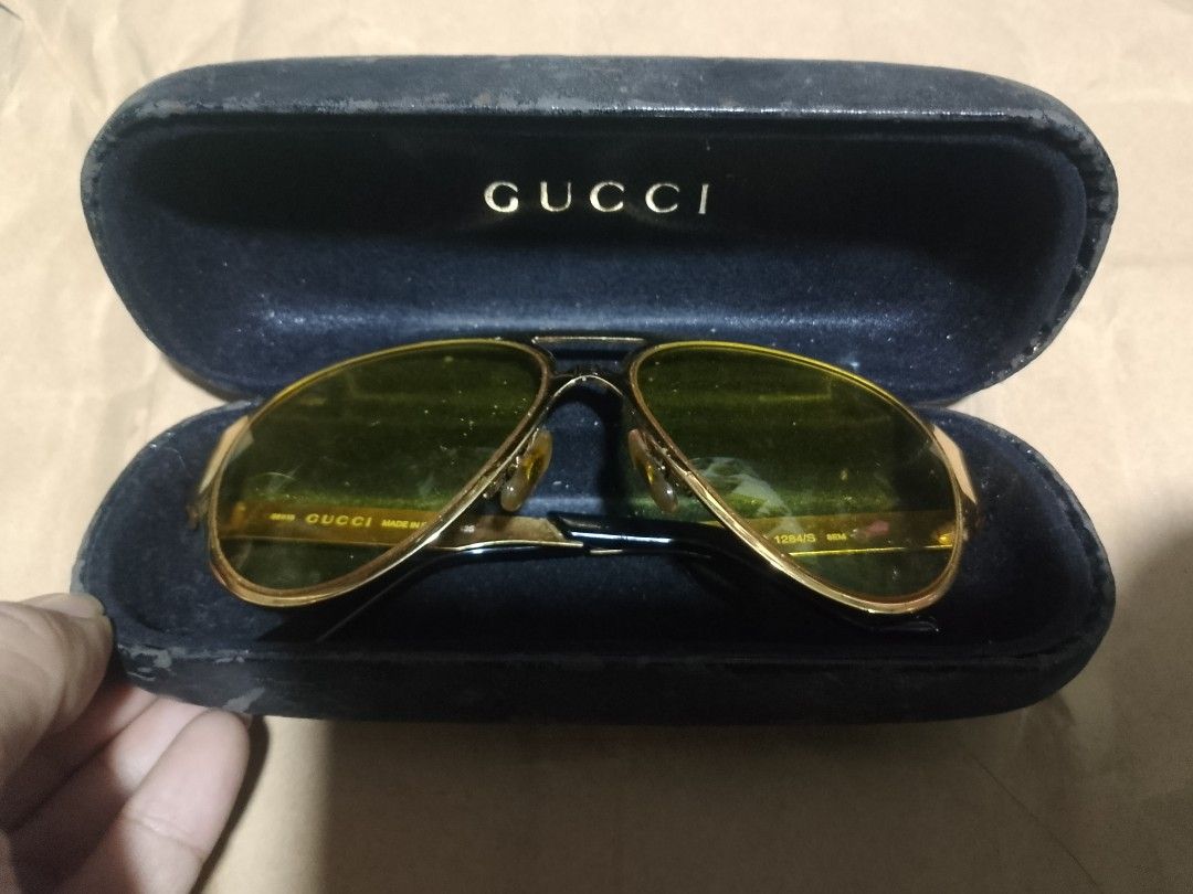 Gucci Aviator Sunglasses GG 1284/S (Category: Sunglasses & Eyewear) located in Manila. Submitted by sheshe.888 (Listing ID 1462834496, Image 2). Description: - Gucci aviator sunglasses - Model: GG 1284/S - Frame: Gold - Lenses: Yellow tinted - Made in Italy - Includes Gucci case - Note: Some signs of wear on frame and case.