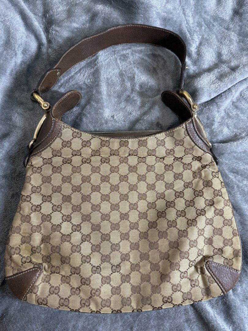 Gucci Monogram Canvas Shoulder Bag (Category: Luxury Bags & Wallets) located in Cainta. Submitted by amswardrobe (Listing ID 1462851180, Image 2). Description: - Classic Gucci monogram shoulder bag - Color: Brown and beige GG canvas with leather trim - Closure: Zipper - Hardware: Gold details - Condition: Shows some signs of wear on leather trim and canvas - Perfect for everyday use.