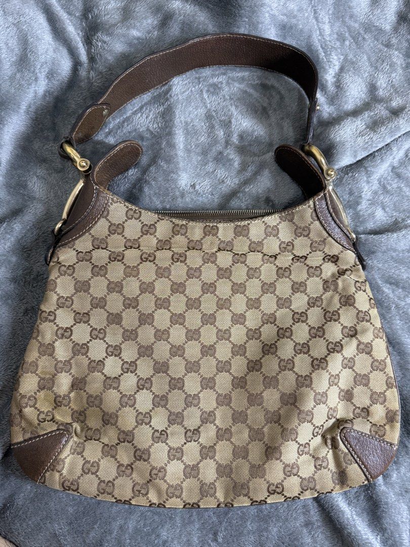 Gucci Monogram Canvas Shoulder Bag (Category: Luxury Bags & Wallets) located in Cainta. Submitted by amswardrobe (Listing ID 1462851180, Image 1). Description: - Classic Gucci monogram shoulder bag - Color: Brown and beige GG canvas with leather trim - Closure: Zipper - Hardware: Gold details - Condition: Shows some signs of wear on leather trim and canvas - Perfect for everyday use.