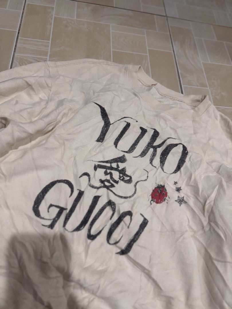 Gucci Yuko Sweatshirt (Category: Longsleeves) located in Alaminos. Submitted by outfitcheck.ph (Listing ID 1462818165, Image 2). Description: - Cream colored sweatshirt - Features 'Yuko Gucci' graphic print on the front - Adorned with a small red ladybug and star details - Long sleeves and crew neck design - Ideal for casual wear - Please check photos for condition details.