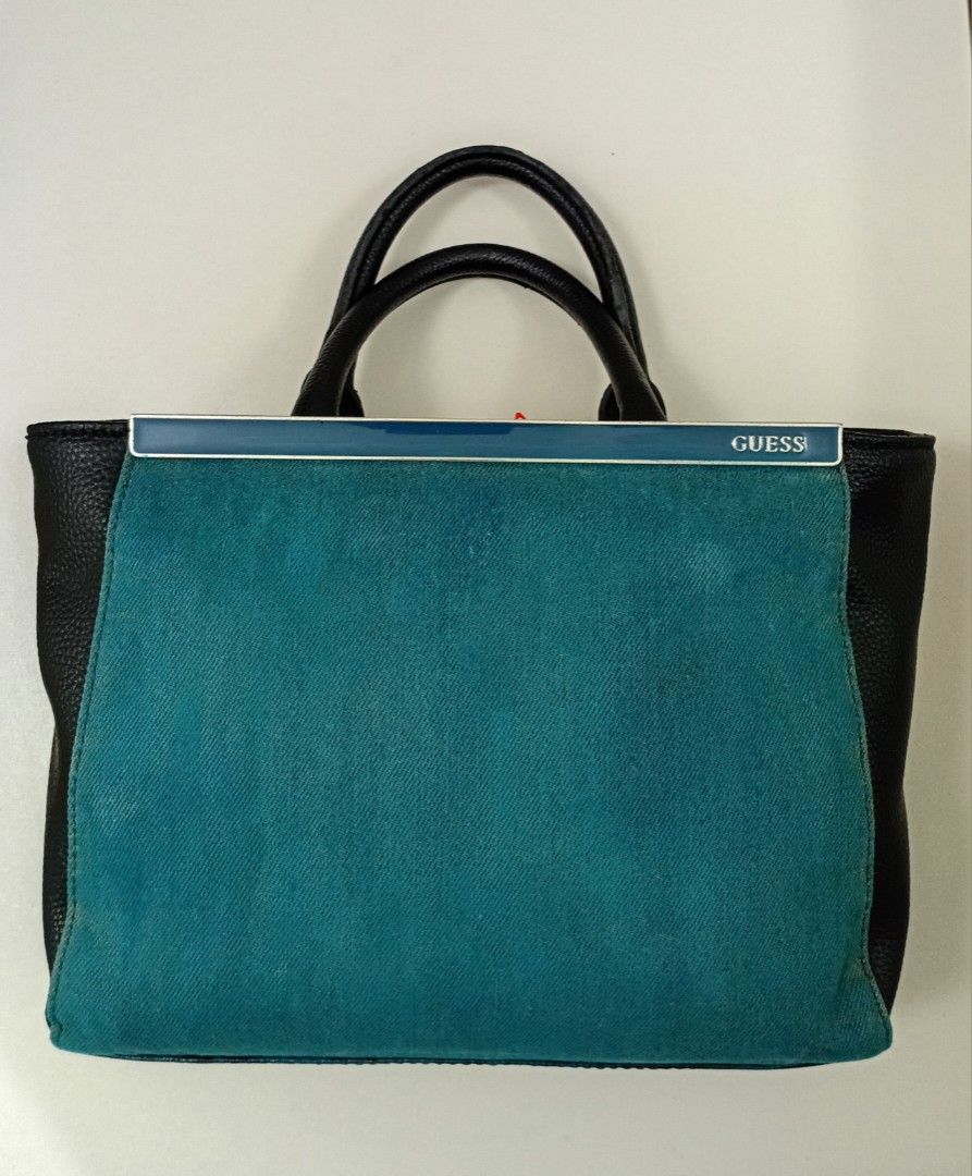 Guess DENIM &Leather handbag (Category: Tote Bags) located in Navotas City. Submitted by ms.soulana (Listing ID 1462875982, Image 1). Description: PreOwned Lightly Used Authentic Guess denim& Leather handbag ,Shoulder,Crossbody bag - Two top handles - Metal clasp closure - Interior zippered pockets - Clean inside and out - Ideal for everyday use wth Detachable Strap for Wearing Crossbody Size Medium Min Sign of Used Sell the bag As is . bag Only 