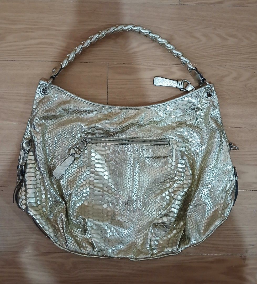 Guess Gold Snake Print Shoulder Bag (Category: Luxury Bags & Wallets) located in Daraga. Submitted by thethriftcity2024 (Listing ID 1462690385, Image 2). Description: - Stylish gold Guess Hobo shoulder bag - Eye-catching snake print texture - Comfortable braided strap - Decorative tassel detail - Front and back zip pockets for secure storage - Interior lined with Guess logo - Durable PVC and polyester material PRISTINE CONDITION 9.8/10 COLOR RATE