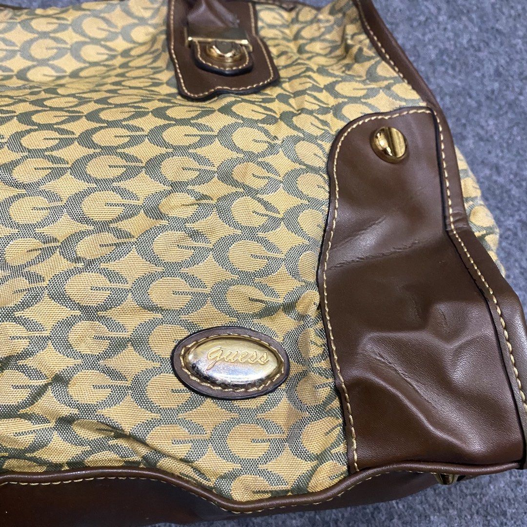 Guess Monogram Canvas & Leather Trim Tote Bag (Category: Tote Bags) located in Cebu City. Submitted by callmejasonx (Listing ID 1462802164, Image 2). Description: - Classic Guess tote bag - Signature 'G' monogram pattern on canvas - Brown leather trim accents - Gold-tone hardware - Spacious interior, perfect for everyday use - Stylish and practical accessory.