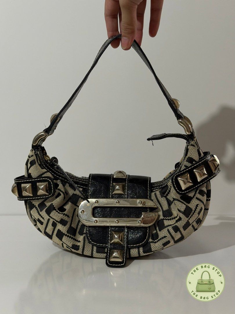 Guess Monogram Shoulder Bag with Studs (Category: Luxury Bags & Wallets) located in Imus. Submitted by thebag_stop.948 (Listing ID 1462756917, Image 1). Description: - Classic Guess monogram print - Silver stud details - Leopard print lining - 8/10.