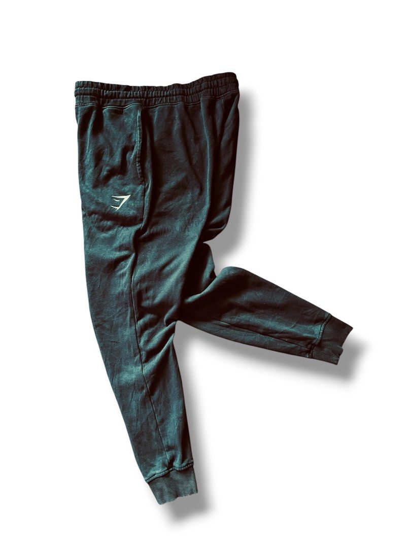 Gymshark Crest Joggers (Category: Announcements) located in Cebu City. Submitted by lchadpierr03463 (Listing ID 1462762481, Image 2). Description: Fit: Slim fit with a tapered leg style that terminates in thick, ribbed ankle cuffs.Waistband: Thick, gathered elastic waistband equipped with an adjustable flat internal/external drawcord. Branding: Features the recognizable Gymshark shark head logo embroidered on the upper left thigh. Storage: Standa