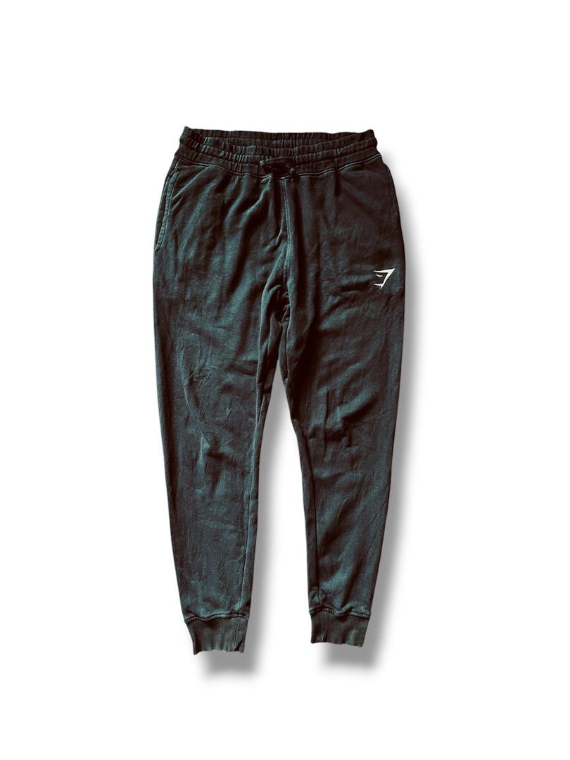 Gymshark Crest Joggers (Category: Announcements) located in Cebu City. Submitted by lchadpierr03463 (Listing ID 1462762481, Image 3). Description: Fit: Slim fit with a tapered leg style that terminates in thick, ribbed ankle cuffs.Waistband: Thick, gathered elastic waistband equipped with an adjustable flat internal/external drawcord. Branding: Features the recognizable Gymshark shark head logo embroidered on the upper left thigh. Storage: Standa