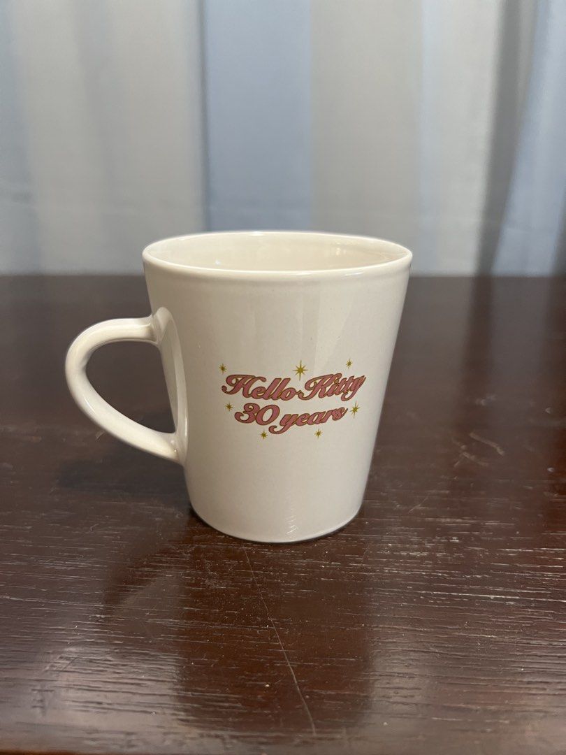 Hello kitty 30th anniv cup (Category: Coffee & Tea Tableware) located in Manila. Submitted by rlab_japan_thrift (Listing ID 1462724404, Image 2). Description: Vintage Sanrio Hello Kitty 30th Anniversary Ceramic Mug (2005) 🎀✨ A rare collectors’ piece for Sanrio enthusiasts! Official 2005 release commemorating Hello Kitty’s 30th Anniversary, featuring charming angel Kitty artwork on the front and retro gold/pink “Hello Kitty 30 years” lettering on