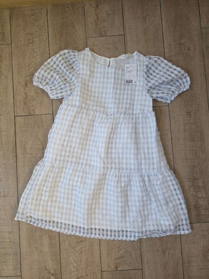 H&M blue checkered dress (Category: Babies & Kids Fashion) located in Quezon City. Submitted by preloved_by_mariekondo (Listing ID 1462780732, Image 1). Description: H&M Signature sheer, puckered seersucker gingham pattern, a delicate buttoned keyhole back closure, and short elasticated balloon sleeves. Size 128 fits 7-8Y runs slightly big.