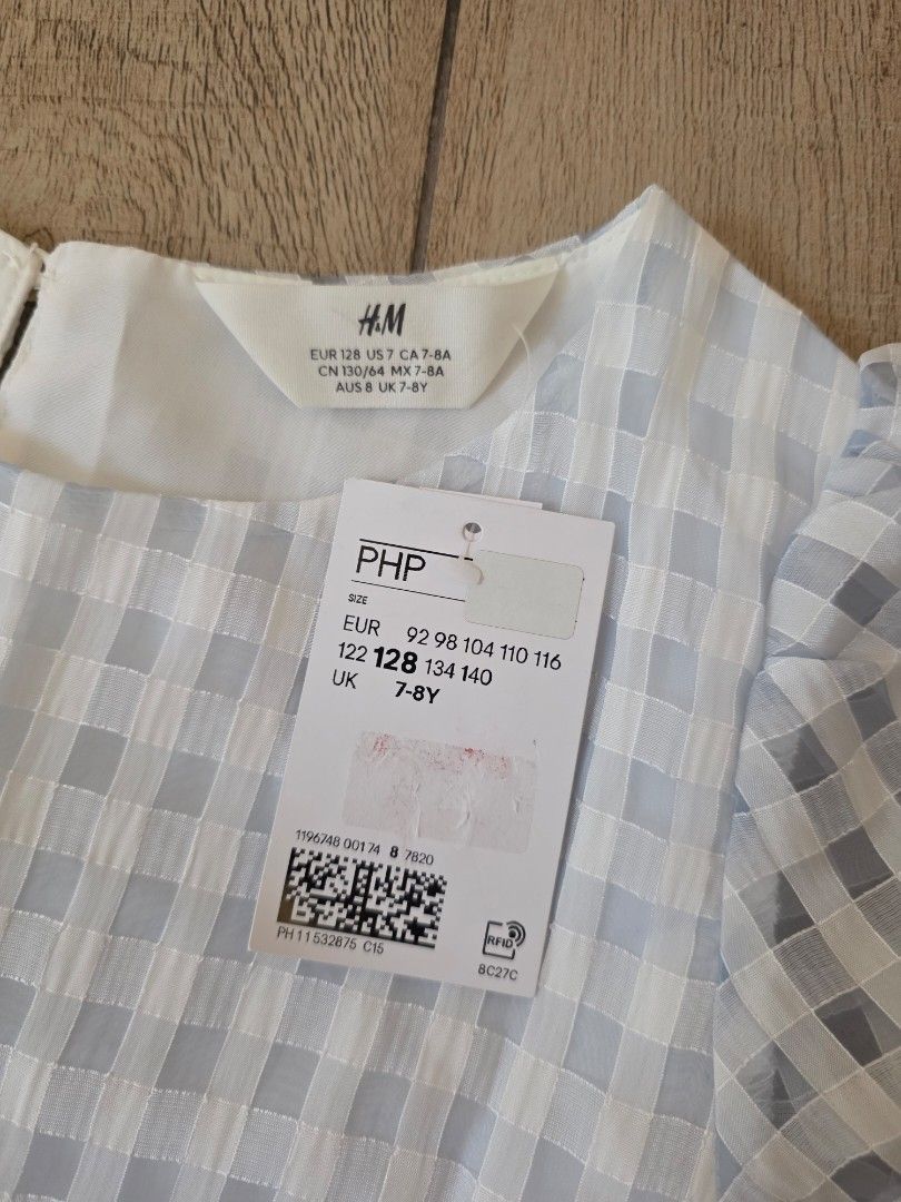 H&M blue checkered dress (Category: Babies & Kids Fashion) located in Quezon City. Submitted by preloved_by_mariekondo (Listing ID 1462780732, Image 2). Description: H&M Signature sheer, puckered seersucker gingham pattern, a delicate buttoned keyhole back closure, and short elasticated balloon sleeves. Size 128 fits 7-8Y runs slightly big.