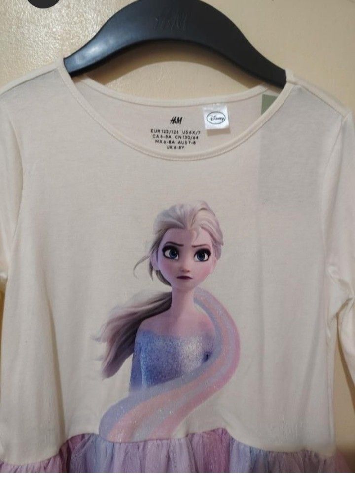 H&M BNWT Disney Frozen (Category: Babies & Kids Fashion) located in Quezon City. Submitted by zabandzycloset (Listing ID 1462745666, Image 2). Description: - Authentic H&M dress featuring Elsa from Frozen. - Long sleeves with a beautiful, sparkly tulle skirt in pastel colors. size: 6-8y on tag - Ideal for any little Frozen enthusiast. - Crafted from 100% recycled polyester. - Brand new with tags still attached..