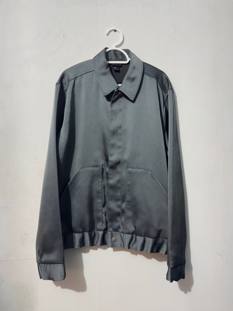 H&M Teal Satin Bomber Jacket (Category: Coats, Jackets and Outerwear) located in Muntinlupa City. Submitted by outmyspace1997 (Listing ID 1462881760, Image 1). Description: - Grey satin bomber jacket from H&M - Size: Medium (M) but can fit up to Large (L) - Features a zip-up front - Two convenient side pockets - Elasticated hem and cuffs for a comfortable fit - Ideal for layering over outfits.