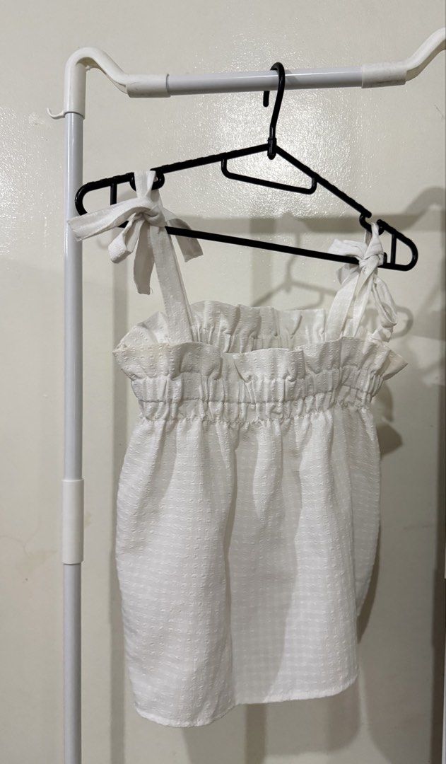 H&M White Textured Tie Strap Smocked Crop Top (Category: Sleeveless) located in Manila. Submitted by lovedbyan (Listing ID 1462878839, Image 1). Description: -XS-S - White H&M crop top - Textured fabric - Smocked bust for a flattering fit - Adjustable tie shoulder straps - Super cute and summery design - Versatile: pairs well with shorts or skirts - Ideal for casual outings.