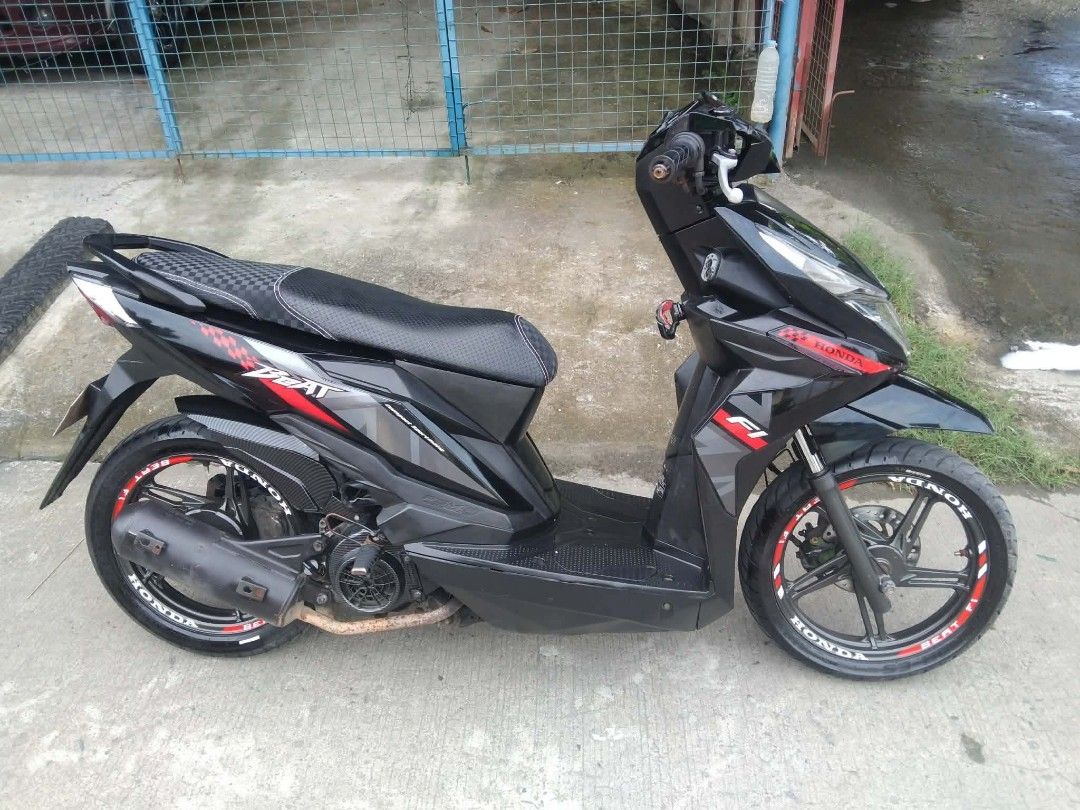 Honda Beat Fi Scooter - Black (Category: Motorbikes for Sale) located in Manila. Submitted by applellame37298 (Listing ID 1462701411, Image 3). Description: Selling my Honda Beat Fi scooter. It's black with red accents. The odometer shows 30415 km. Tires have custom decals. Ready for a new owner. Message me for details. negotiable price.