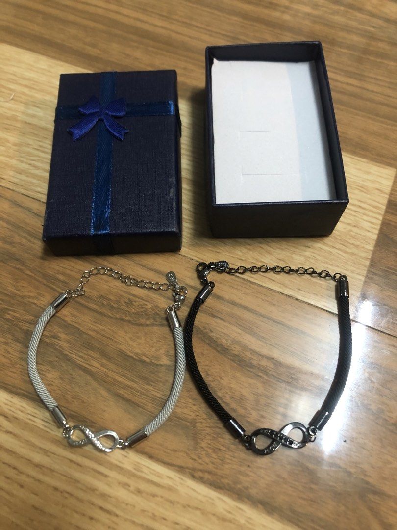Infinity Bracelets with Gift Box (Category: Bracelets) located in Manila. Submitted by ysa_crafts (Listing ID 1462816975, Image 1). Description: - Set includes two infinity bracelets. - One silver-toned bracelet with a mesh band. - One black bracelet with a braided cord band. - Both bracelets feature adjustable chains. - Comes with a dark blue gift box and ribbon. - Ideal for gifting or coordinating with a friend..