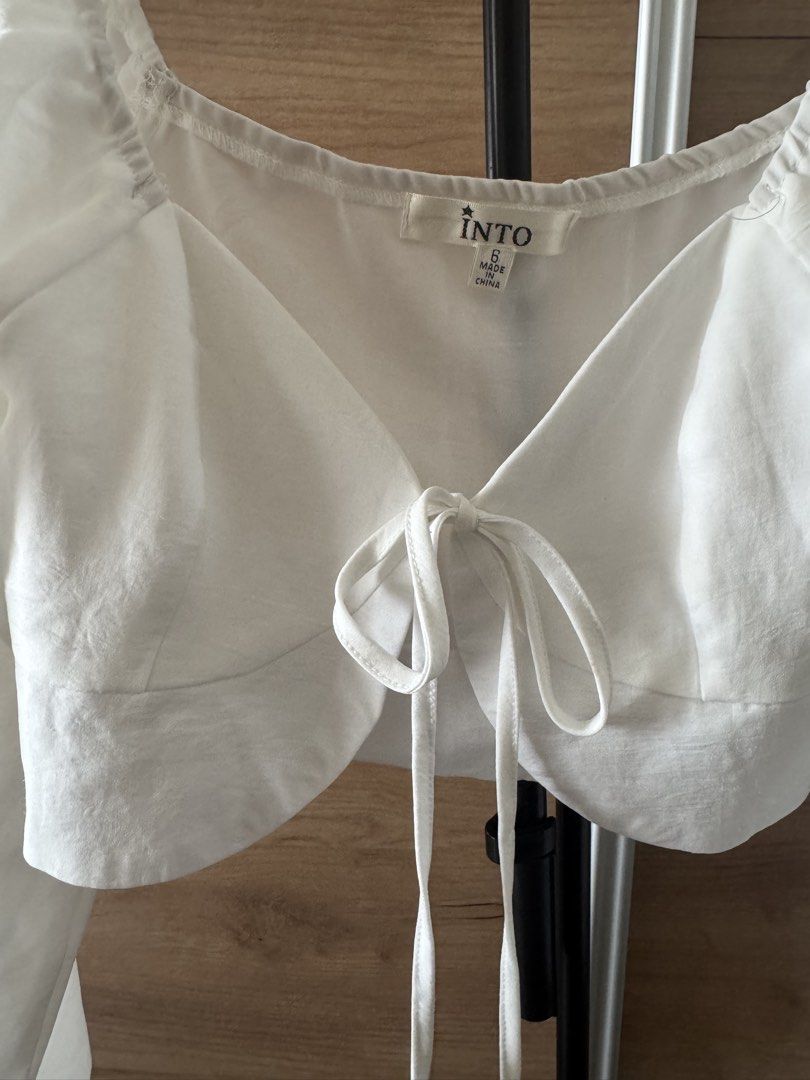 INTO White Tie Front Long Sleeve Crop Top Size 6 (Category: Blouses) located in Quezon City. Submitted by hereshecams (Listing ID 1462719482, Image 2). Description: - Cute white crop top from INTO - Features a tie front detail - Long puff sleeves - Versatile: pairs well with jeans or skirts - Perfect for casual outings or nights with friends - Size: 6.