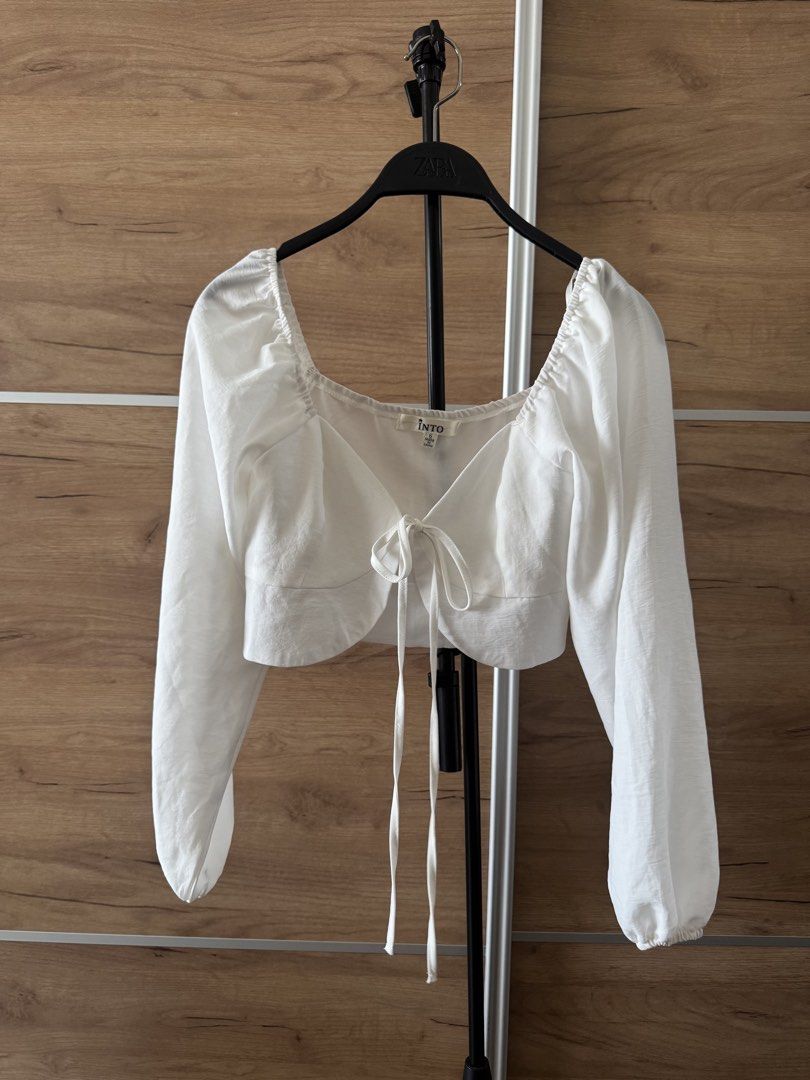INTO White Tie Front Long Sleeve Crop Top Size 6 (Category: Blouses) located in Quezon City. Submitted by hereshecams (Listing ID 1462719482, Image 1). Description: - Cute white crop top from INTO - Features a tie front detail - Long puff sleeves - Versatile: pairs well with jeans or skirts - Perfect for casual outings or nights with friends - Size: 6.