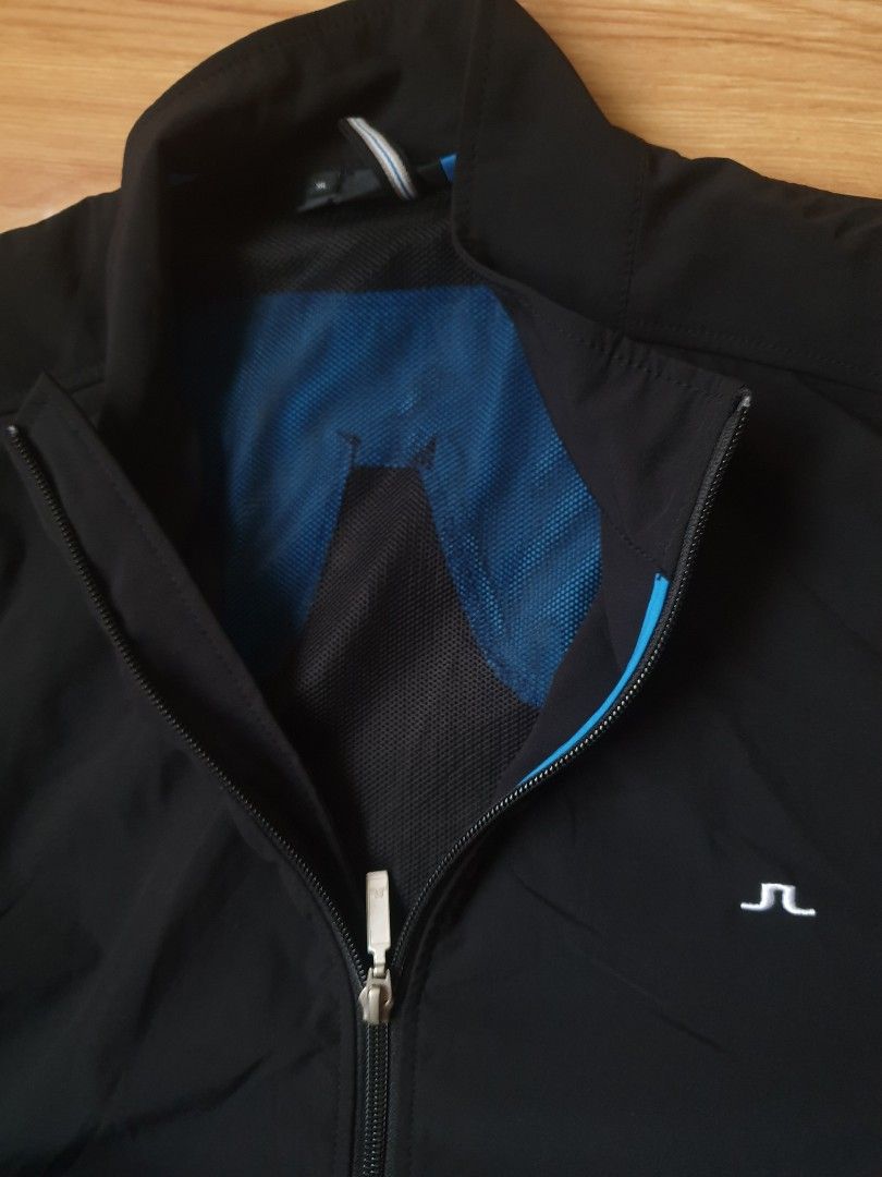Authentic j.lindeberg golf track jacket / windbreak (Category: Coats, Jackets and Outerwear) located in Makati City. Submitted by nvdluxurygoods (Listing ID 1462804417, Image 3). Description: no flaws, no issue Black J.Lindeberg golf track jacket / windbreak full-zip athletic jacket featuring a striking bright blue stripe down the right sleeve..