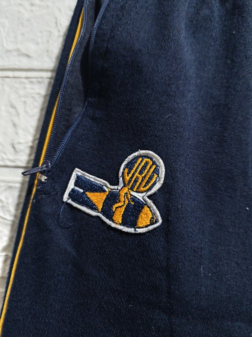 JRU jogging pants (Category: Other Bottoms) located in Pasay City. Submitted by clotheslinemanila (Listing ID 1462769385, Image 2). Description: - Navy blue track pants - Yellow stripes down the sides - Embroidered cute bee logo on the left leg - Elastic waistband with drawstring - Side pockets - Ideal for sports or casual wear.