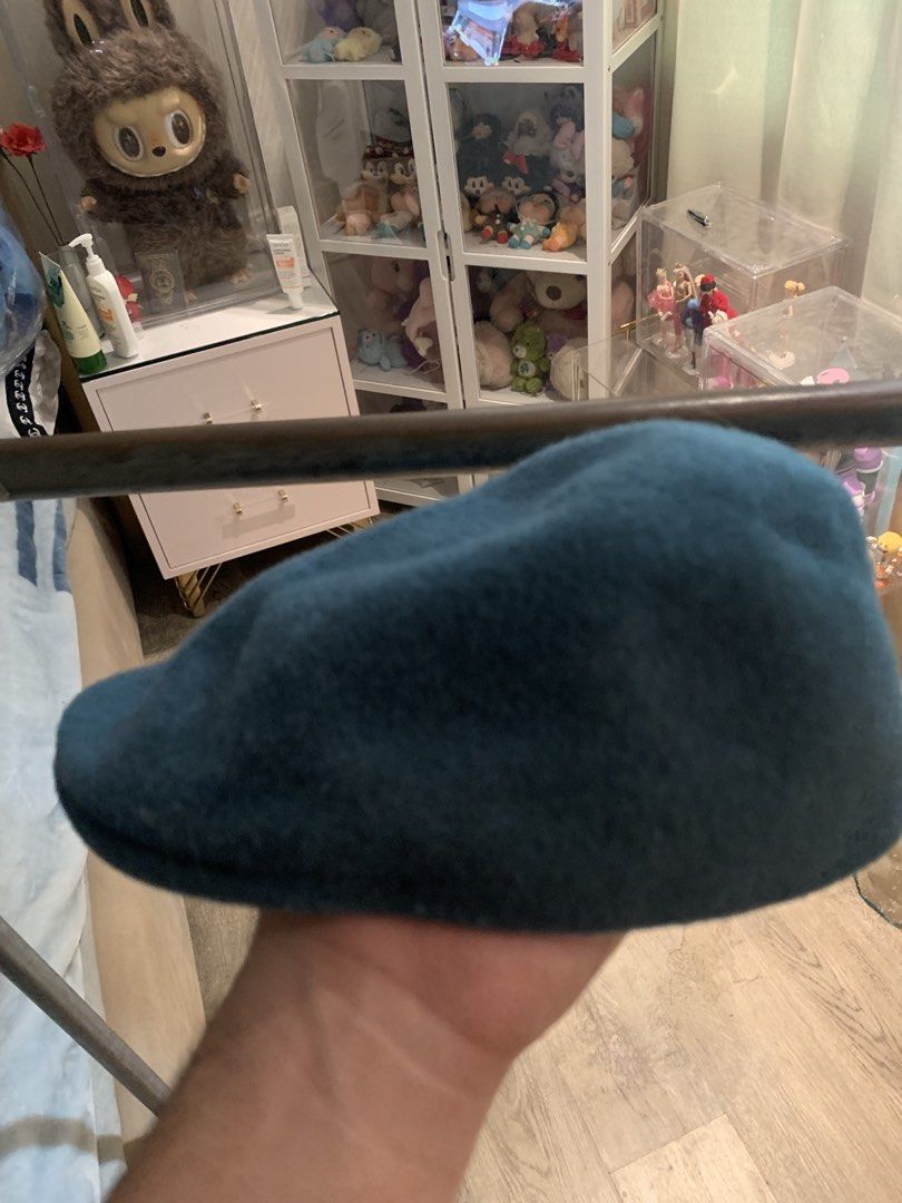 Kangol Teal Wool Blend Flat Cap Hat (Category: Caps & Hats) located in Manila. Submitted by vintaurafindsco. (Listing ID 1462795407, Image 2). Description: - Teal Kangol flat cap - Wool blend material - Size: ME - Made in China - Perfect for casual outfits - Features the signature Kangol kangaroo logo on the back - Purchased some time ago, but has seen minimal to no use.
