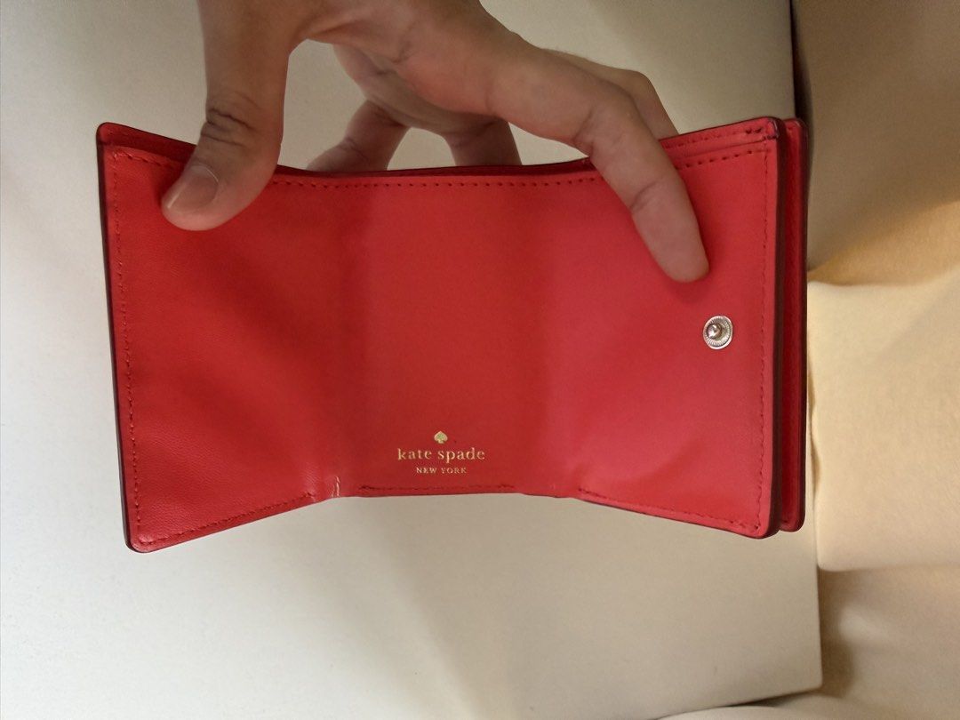 Kate Spade New York Trifold Wallet (Category: Wallets & Card holders) located in Angeles City. Submitted by decluttering.kimmmyyy (Listing ID 1462724561, Image 3). Description: Red Kate Spade Trifold Wallet in Saffiano Leather Rfs: Decluttering.