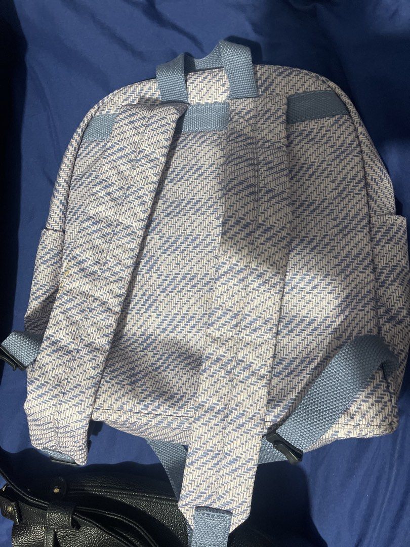 Kipling Backpack with Monkey Charm (Category: Backpacks) located in Manila. Submitted by abeline07 (Listing ID 1462872481, Image 3). Description: - Adorable Kipling backpack with a stylish light purple and white herringbone pattern. - Multiple zippered pockets on the front for quick access to essentials. - Spacious main compartment opens wide for easy packing and retrieval. - Adjustable straps ensure a comfortable fit for everyone. - Includes the