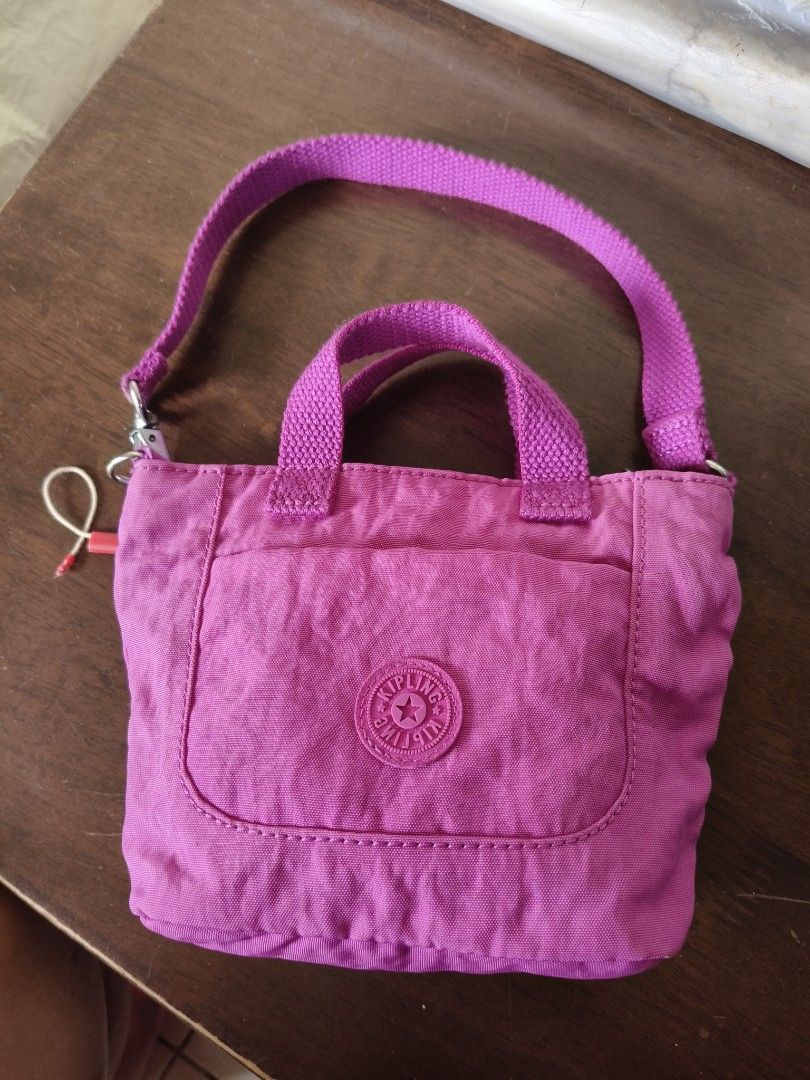 Kipling Mini Bag (Category: Cross-body Bags) located in Santa Rosa. Submitted by iammarien2nette (Listing ID 1462749312, Image 1). Description: - Cute Kipling mini bag/pouch in vibrant pink color. - Interior lined with a fun polka dot pattern. - Secure zip-top closure. - Like new. .