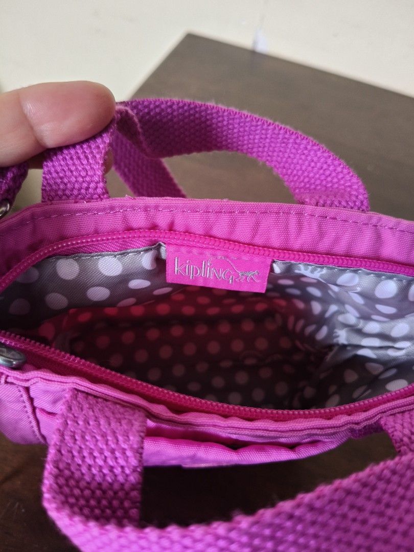 Kipling Mini Bag (Category: Cross-body Bags) located in Santa Rosa. Submitted by iammarien2nette (Listing ID 1462749312, Image 3). Description: - Cute Kipling mini bag/pouch in vibrant pink color. - Interior lined with a fun polka dot pattern. - Secure zip-top closure. - Like new. .