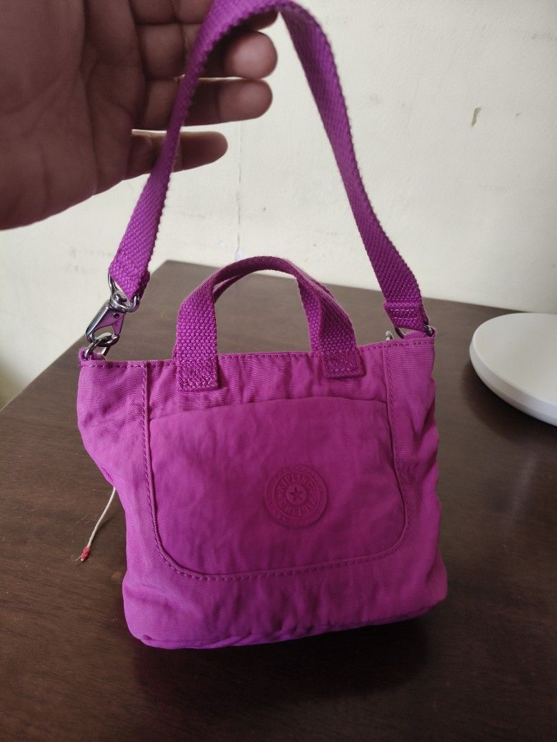 Kipling Mini Bag (Category: Cross-body Bags) located in Santa Rosa. Submitted by iammarien2nette (Listing ID 1462749312, Image 2). Description: - Cute Kipling mini bag/pouch in vibrant pink color. - Interior lined with a fun polka dot pattern. - Secure zip-top closure. - Like new. .