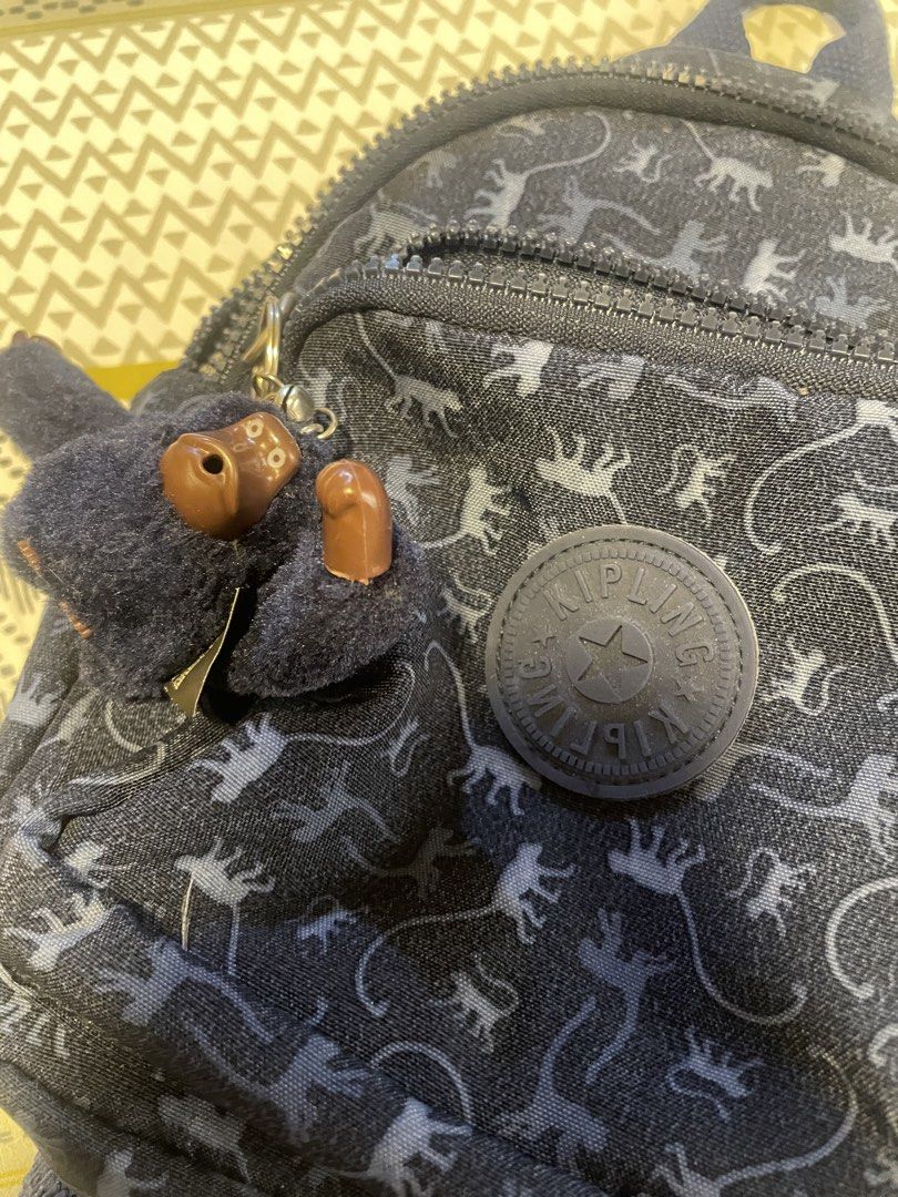 Kipling Mini Convertible Backpack (Category: Backpacks) located in San Jose. Submitted by vvcarmen (Listing ID 1462768055, Image 1). Description: Hindi na nagagamit 2x lang nagamit during travel good as new. Bought this at the mall brand new for ₱4,000 Selling price ₱2,500 (free shipping) Very steal super like new pa ‘to - Super Cute Kipling mini backpack - Dark blue with fun dinosaur print - Includes classic Kipling monkey charm - Adjustable str