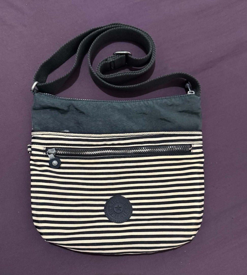Kipling Striped Crossbody Bag (Category: Cross-body Bags) located in Bacolod City. Submitted by asheroth77 (Listing ID 1462688609, Image 1). Description: - Classic Kipling crossbody bag - Stylish black and white stripe pattern - Adjustable strap for comfortable carrying - Multiple zippered compartments for secure storage - Interior pockets for added organization - Durable nylon material, built to last - Ideal for everyday use.