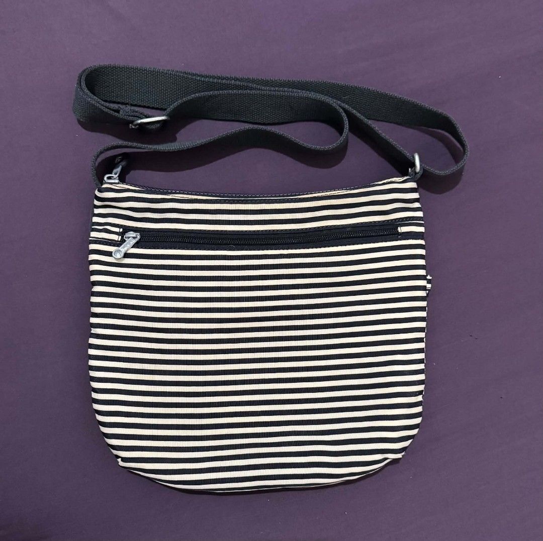 Kipling Striped Crossbody Bag (Category: Cross-body Bags) located in Bacolod City. Submitted by asheroth77 (Listing ID 1462688609, Image 2). Description: - Classic Kipling crossbody bag - Stylish black and white stripe pattern - Adjustable strap for comfortable carrying - Multiple zippered compartments for secure storage - Interior pockets for added organization - Durable nylon material, built to last - Ideal for everyday use.