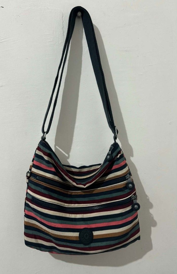 Kipling Striped Crossbody Bag with Multiple Zippers (Category: Cross-body Bags) located in Bacolod City. Submitted by asheroth77 (Listing ID 1462688655, Image 3). Description: - Cute Kipling crossbody bag - Fun stripe pattern - Multiple zippered compartments for organization - Adjustable strap for comfortable wear - Great for everyday use or travel - Durable material.