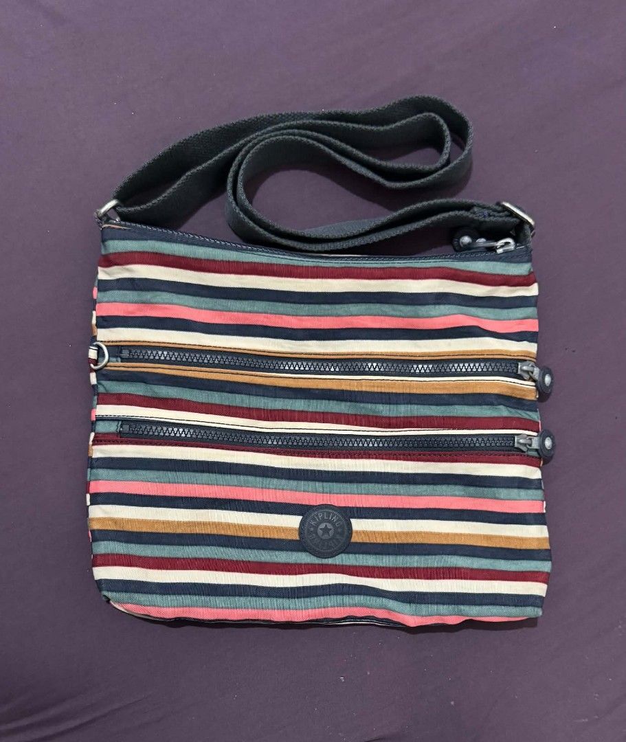 Kipling Striped Crossbody Bag with Multiple Zippers (Category: Cross-body Bags) located in Bacolod City. Submitted by asheroth77 (Listing ID 1462688655, Image 1). Description: - Cute Kipling crossbody bag - Fun stripe pattern - Multiple zippered compartments for organization - Adjustable strap for comfortable wear - Great for everyday use or travel - Durable material.