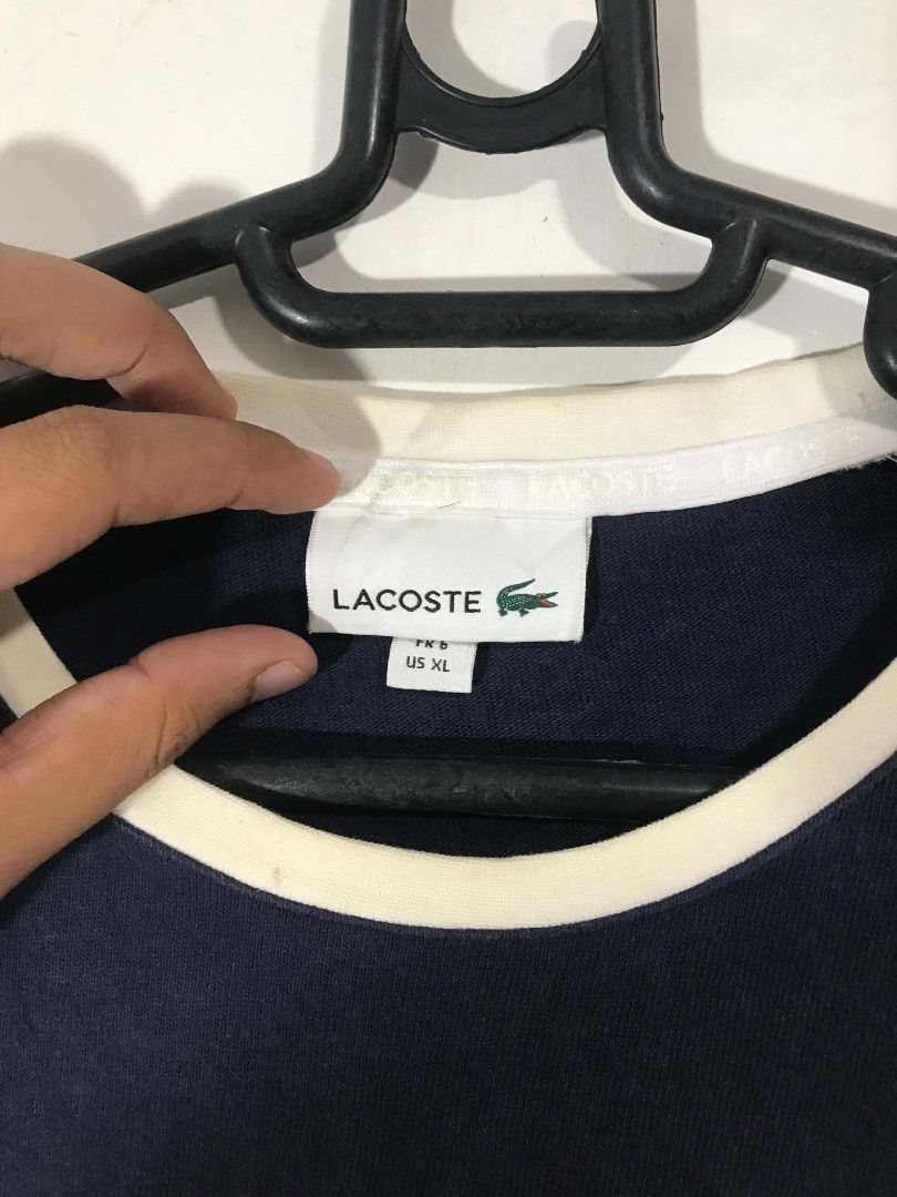 Lacoste stripe long sleeve (Category: Activewear) located in Ajuy. Submitted by anniee_tee (Listing ID 1462865827, Image 2). Description: Issue: discoloration on shoulder sleeve.