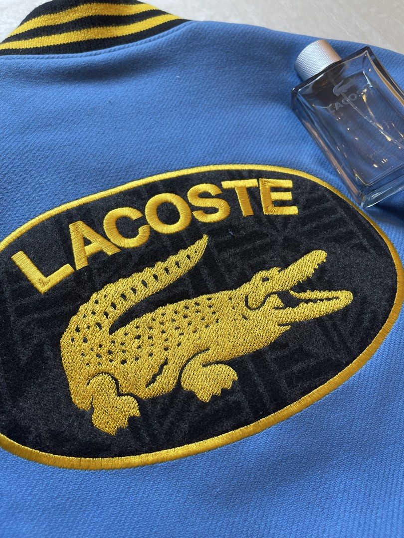 Lacoste Teddy Varsity Jacket XL Unisex (Category: Coats, Jackets and Outerwear) located in Quezon City. Submitted by justinmark0207 (Listing ID 1462814205, Image 3). Description: - Authentic Lacoste varsity jacket - Color: Blue body with black sleeves - Features: Patches and embroidery - Style: Ribbed cuffs and hem - Size: Unisex XL - Condition: Brand new with original tags attached - Original Retail Price: $795.00 - Selling Price: 25,000 Pesos ☎