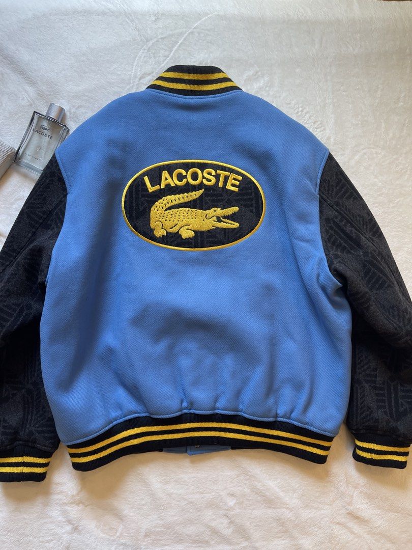 Lacoste Teddy Varsity Jacket XL Unisex (Category: Coats, Jackets and Outerwear) located in Quezon City. Submitted by justinmark0207 (Listing ID 1462814205, Image 2). Description: - Authentic Lacoste varsity jacket - Color: Blue body with black sleeves - Features: Patches and embroidery - Style: Ribbed cuffs and hem - Size: Unisex XL - Condition: Brand new with original tags attached - Original Retail Price: $795.00 - Selling Price: 25,000 Pesos ☎