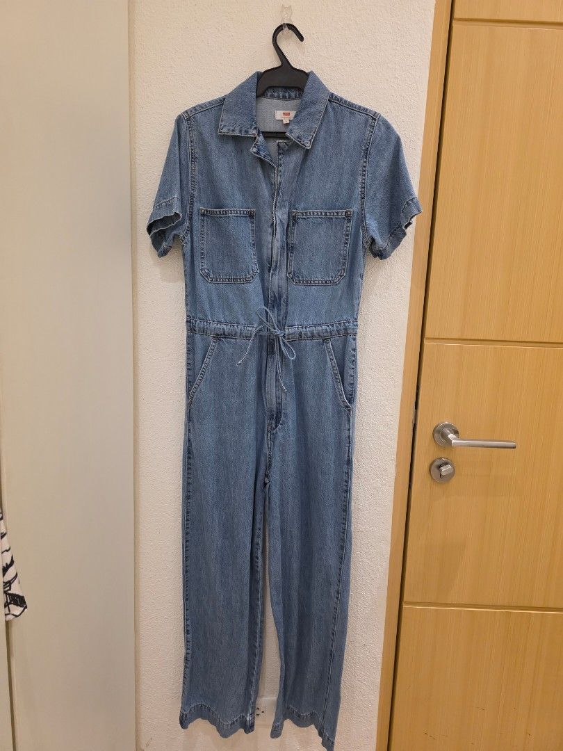 Levi's Denim Jumpsuit (Category: Jumpsuits) located in Quezon City. Submitted by preloved_by_mariekondo (Listing ID 1462835427, Image 2). Description: Levi's Short Sleeve Denim Jumpsuit Classic relaxed straight-leg silhouette, a front zip fastening, short sleeves, practical chest patch pockets, and an adjustable drawstring or tie at the cinched waist. Size Small, can fit Medium Model in picture is tall, like 5'9". For someone 5'2" pant leg is rig