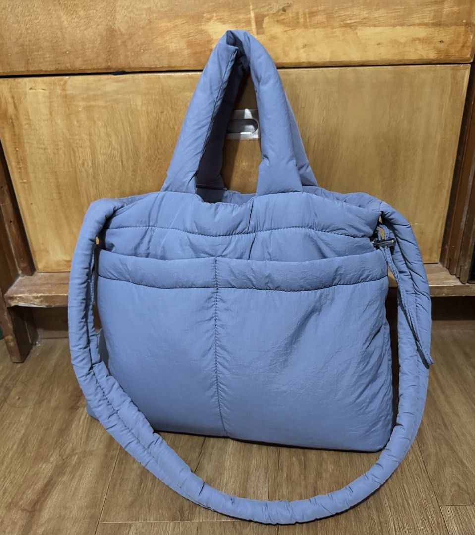 Light Blue Puffer Tote Bag (Category: Tote Bags) located in Manila. Submitted by jrc1994 (Listing ID 1462868430, Image 2). Description: - Adorable puffy tote bag - Chic light blue color - Very spacious interior - Convenient front pocket - Secure drawstring closure - Comfortable padded handles - Ideal for everyday errands or travel - Comes with original tag attached -RSF decluttering -LP 800.