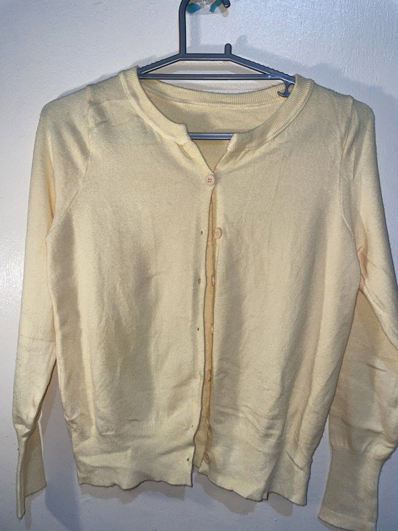 Light Yellow Button-Up Long Sleeve Cardigan (Category: Coats, Jackets and Outerwear) located in Manila. Submitted by sammmm777 (Listing ID 1462761303, Image 2). Description: - Soft pale yellow knit cardigan - Comfortable crew neck with button-up front - Long sleeves with ribbed cuffs and hem - Perfect for layering - Note: Small marks present on fabric (see close-up photo).
