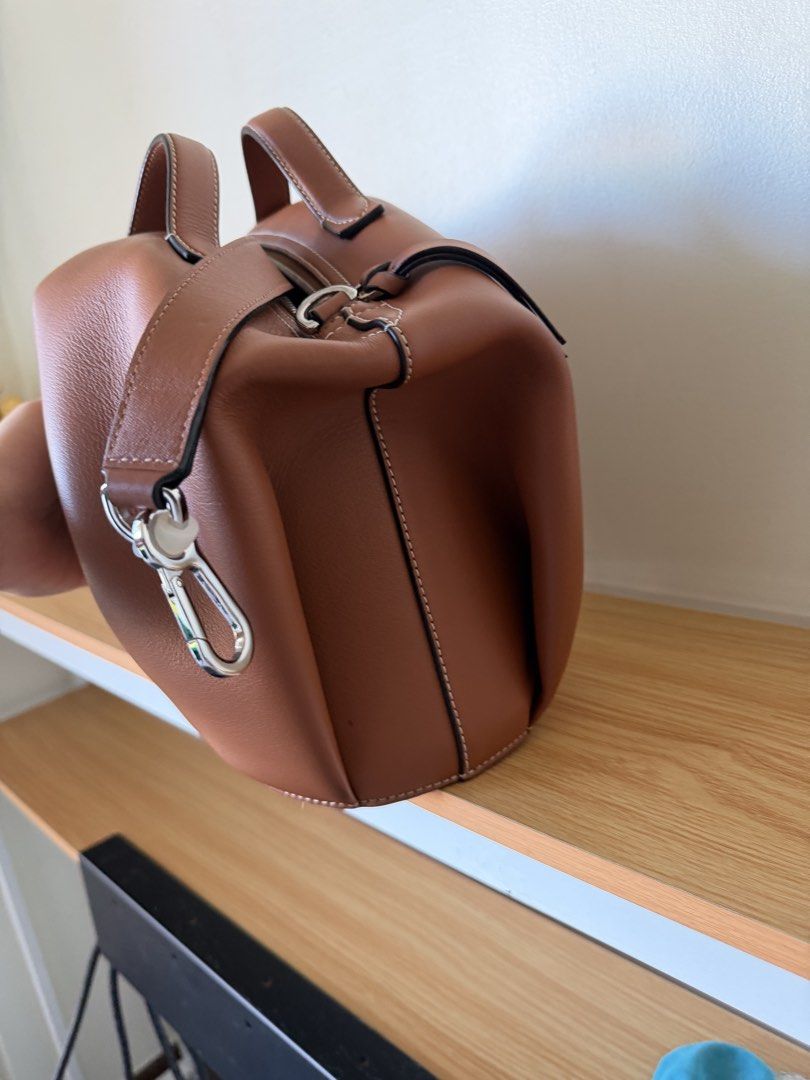 Loewe Elephant Bag (Category: Luxury Bags & Wallets) located in Quezon City. Submitted by sourcemanila (Listing ID 1462865455, Image 3). Description: - Authentic Loewe elephant bag - Rich brown leather - Unique and eye-catching design - Secure zipper closure - Light-colored fabric interior lining - Comes with original Loewe box - Perfect statement accessory.