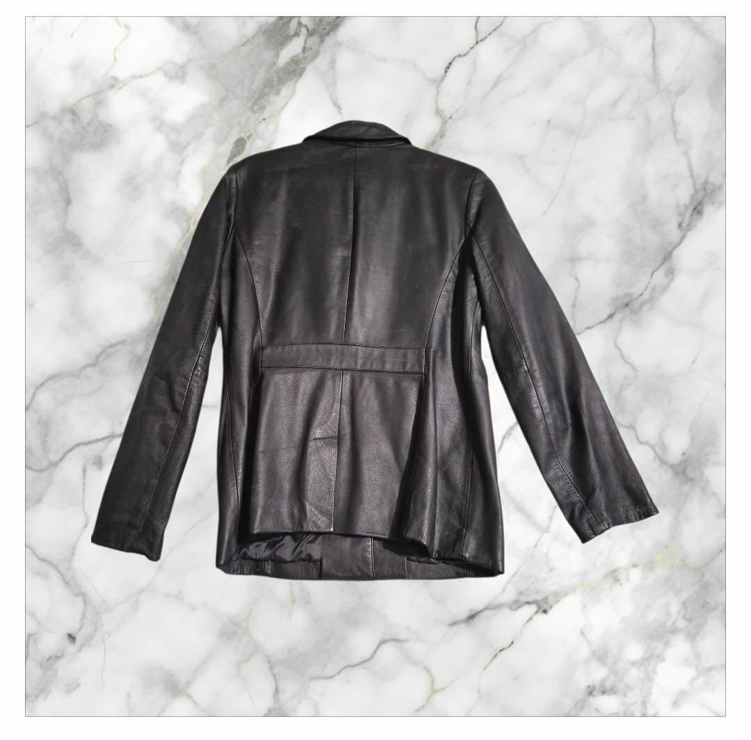 Loft Leather Jacket (Category: Others Tops) located in Paranaque City. Submitted by calm_youngstore7 (Listing ID 1462807270, Image 3). Description: Black leather blazer-style jacket from the brand LOFT. It features a single-breasted three-button front closure, classic notch lapels, structural panel stitching, and two slanted front waist pockets. This tailored silhouette is highly sought after as a versatile, minimalist staple piece..