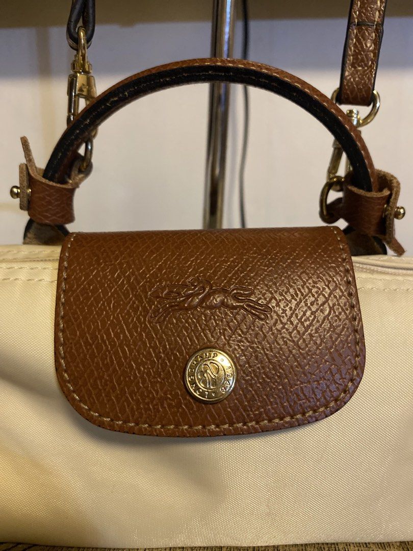 Longchamp Le Pliage Small (Category: Luxury Bags & Wallets) located in Tagum. Submitted by luxeukayfinds_ (Listing ID 1462822449, Image 2). Description: ‼️ SCAN EACH PHOTOS FOR EVERY DETAIL OF THE BAGS‼️ - Authentic Cream Longchamp Bag - Brown Leather Trim & Handles - Detachable Shoulder Strap Included - Compact Size (Ideal for Essentials) - Gold Hardware Accents.