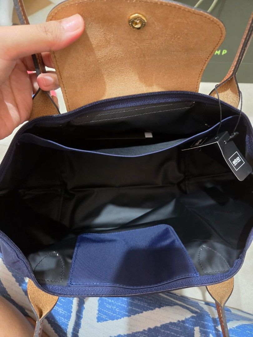 Longchamp Le Pliage Tote Bag Navy Blue (Category: Luxury Bags & Wallets) located in Manila. Submitted by rabbitprimavera (Listing ID 1462863747, Image 3). Description: - Authentic Longchamp Le Pliage tote bag in Large - Classic navy blue nylon with brown leather handles and trim - Includes original shopping bag and tag - Bought in Istanbul 1 week ago - Can provide proof of purchase (receipt) rfs: extra.