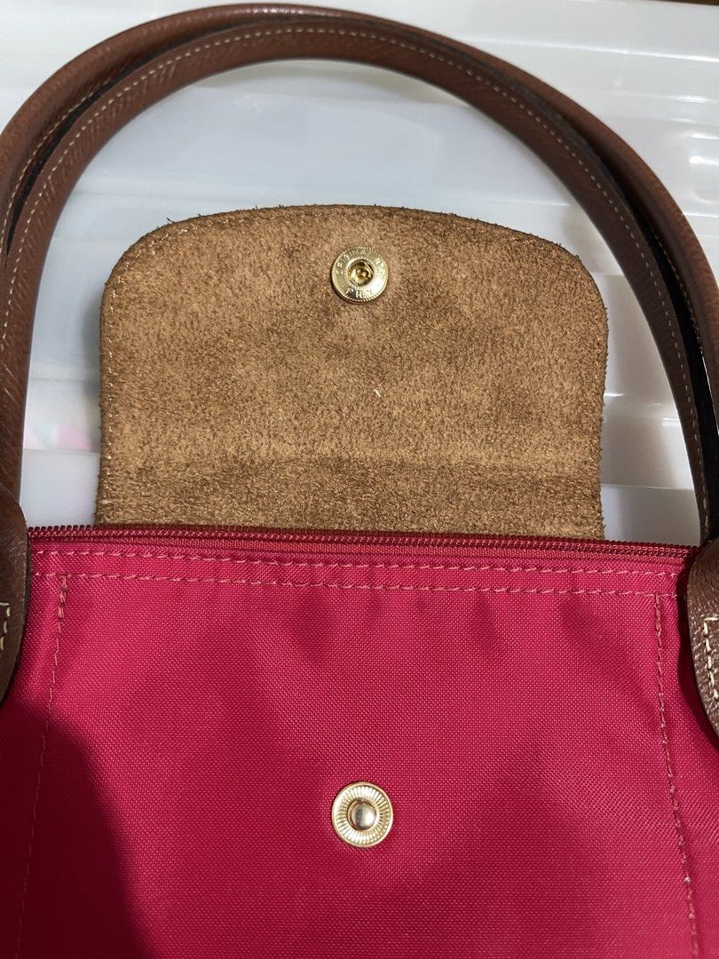 Longchamp Paris Red Nylon Tote Bag (Category: Luxury Bags & Wallets) located in Paranaque City. Submitted by alexagamboa (Listing ID 1462825712, Image 2). Description: - Red Longchamp tote bag - Made in China - Genuine leather handles and trim - Secure zipper closure with snap button flap - Very spacious, ideal for everyday essentials - A great everyday carry-all!.